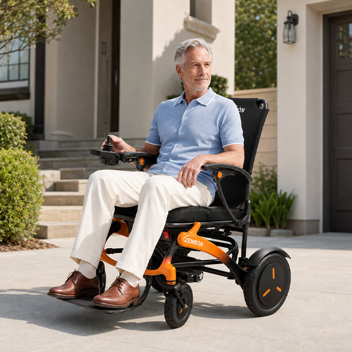 Adult using the ZENBON FoldX electric wheelchair outdoors on a patio