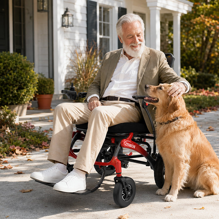 Adult with a dog using the ZENBON FoldX Pro electric wheelchair outdoors
